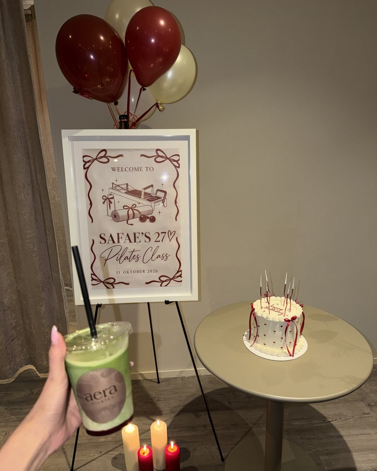 A birthday class set-up at aera with balloons, a welcome sign, cake and an aera matcha